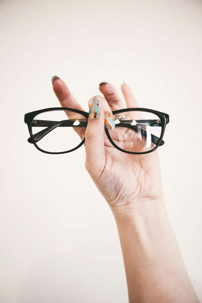 Photo of Person Holding Eyeglasses